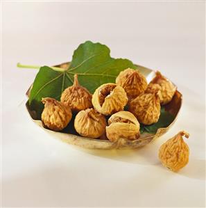 Dried fig on leaf in silver bowl