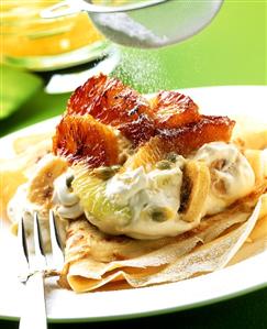 Crepe with quark, exotic fruit and icing sugar