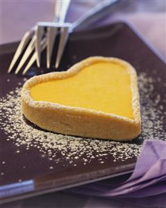 Heart-shaped lemon tartlet with icing sugar