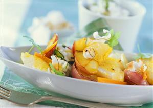 Fish curry with apples, coconut shavings and rice