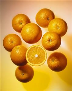 Oranges, one halved