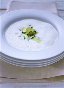 White creamed tomato soup with rocket soup garnish