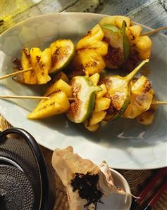 Fried fig and pineapple kebabs; teapot and tea leaves