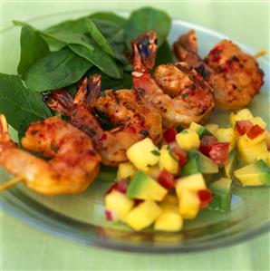 Shrimp kebab with spinach and pineapple and avocado salsa