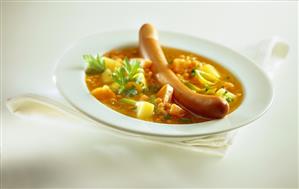 Potato and carrot stew with lentils and sausages