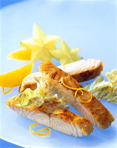 Strips of fried salmon, garnished with fruit and salad