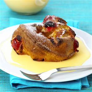 Bread pudding with candied fruits and custard