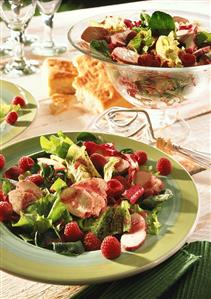 Iceberg lettuce with chicken fillet and raspberries