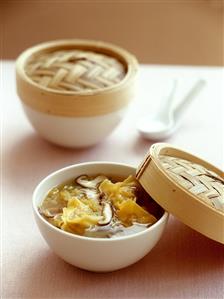 Asian chicken soup with mushrooms and won tons