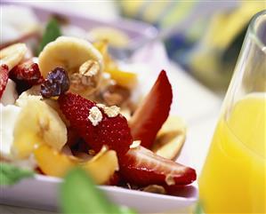 Fruit salad with rolled oats; orange juice