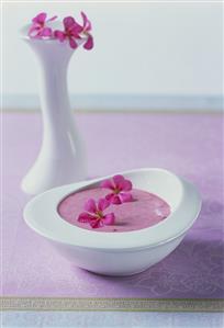 Raspberry yoghurt with edible flowers