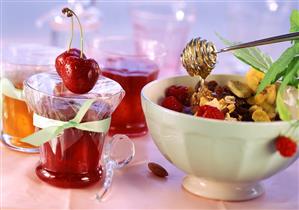 Various jams and fruit muesli with honey