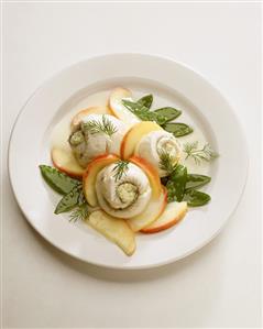 Saffron fish rolls with apple wedges and dill