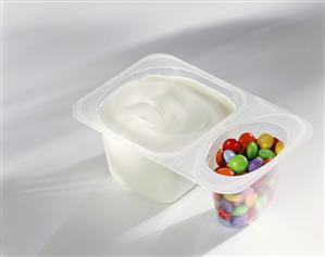 Yoghurt with coloured chocolate beans in pot