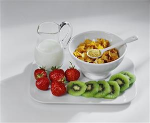 Cornflakes, milk, fresh strawberries and kiwi fruits