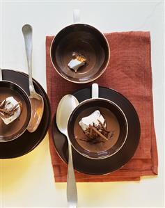 Chocolate soup with chocolate curls and beaten egg white