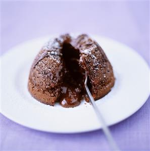 Chocolate pudding with icing sugar and chocolate sauce