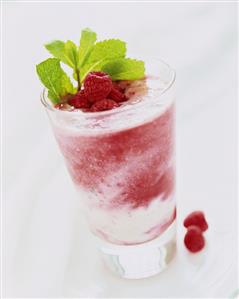 Raspberry smoothie with sprig of mint