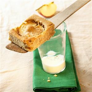 A piece of quick apple cake on a glass of milk