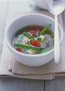 Miso soup with tofu, tomatoes and mangetout peas