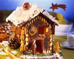 Gingerbread house with chocolate, nuts and almonds