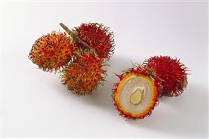 Whole and halved rambutan