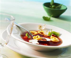 Tomato consomme with tortellini and mushrooms