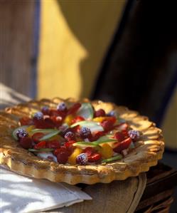 Fruit tart with berries, oranges and apple