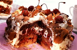 Black Forest cherry gateau with grated chocolate, a piece cut