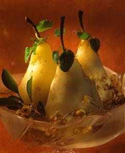 Three poached pears with mint leaves