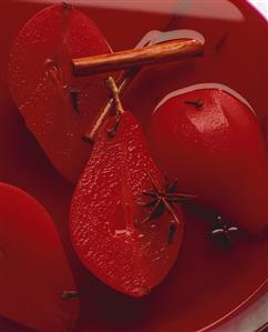 Pear in red wine with anise, cloves and cinnamon (close-up)