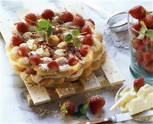 Strawberry cake with white chocolate on wooden rack (1)