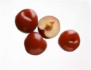 Three red plums and half a plum