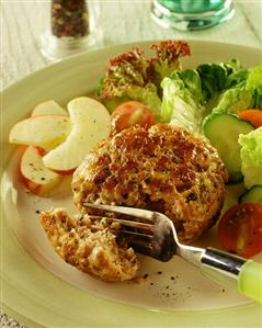 Apple and meat frikadelle, with salad and apple slices