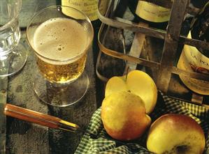 A glass of cider; apples and cider bottles (1)