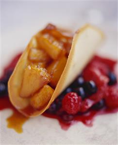 Baked pineapple in pastry case on fruit sauce