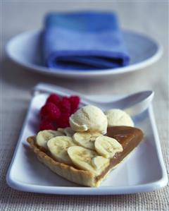 Banana and caramel tart with ice cream and raspberries