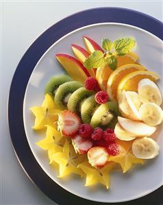 Slices of fruit and berries on plate