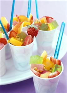 Fruit salad with jelly cubes in plastic pots