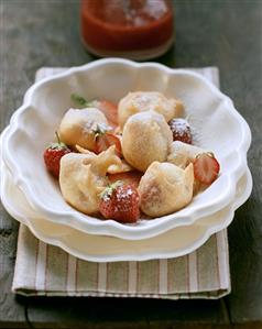 Strawberry fritters with icing sugar