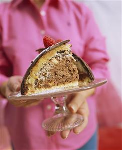 Woman serving zuccotto cake on cake plate