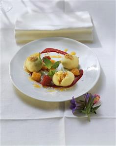 Apricot dumplings with buttered breadcrumbs and raspberry sauce