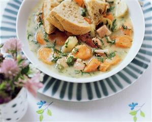 Carrot stew with smoked bacon and pieces of bread