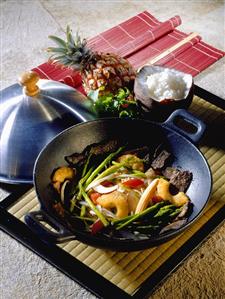 Vegetables cooked in wok with pineapple; rice