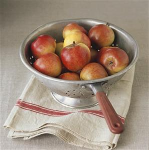 Fresh red apples in colander