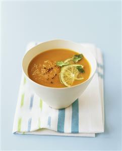 Pumpkin and coconut soup with lime and coriander leaves