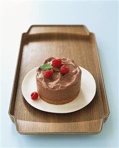 Small chocolate mousse cake with raspberries