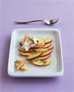 Peaches with lime sauce, rose petals, cream, pistachios