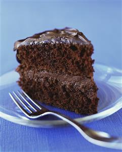 Piece of chocolate cake on glass plate