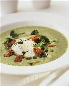 Broccoli soup with poached egg and toasted almonds